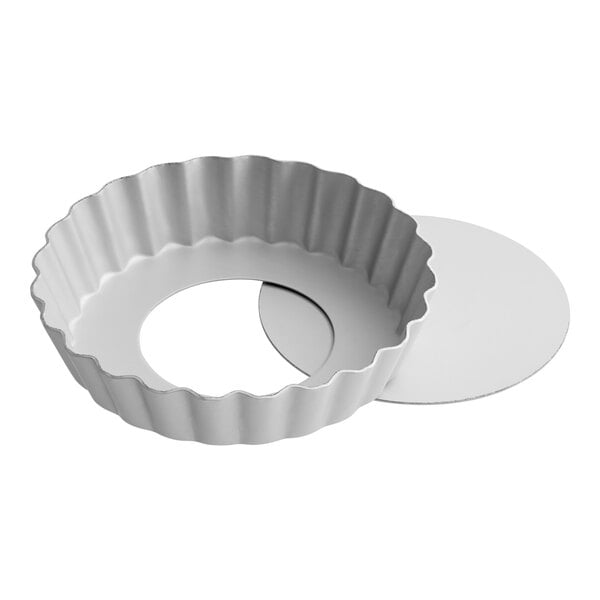 A white round Fat Daddio's fluted tart / quiche pan with a silver circle at the bottom.