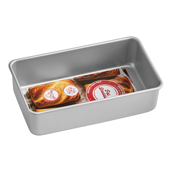 A Fat Daddio's anodized aluminum bread loaf pan with two loaves of bread inside.