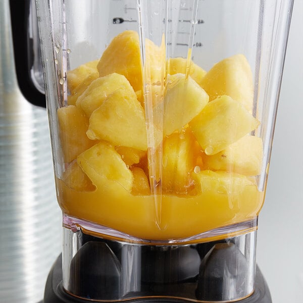 A blender full of IQF diced pineapple chunks.