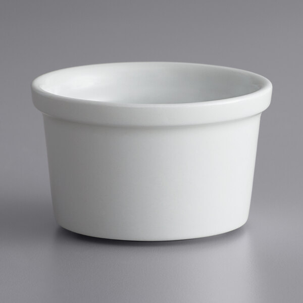 A close up of a bright white Corona porcelain ramekin.