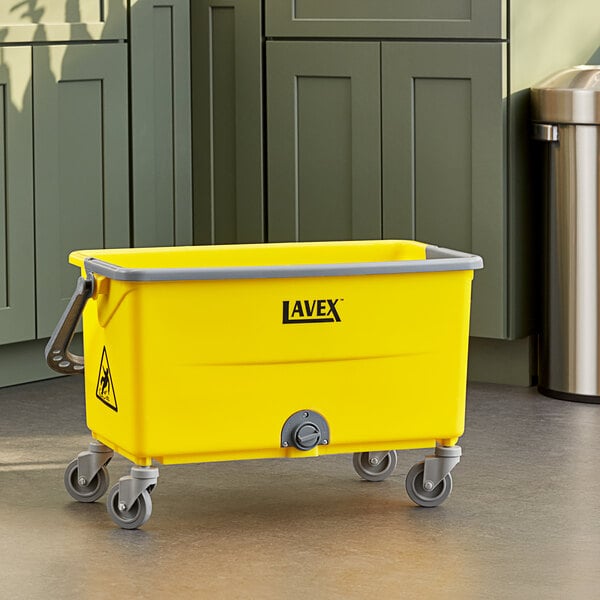 A yellow Lavex mop bucket on wheels.