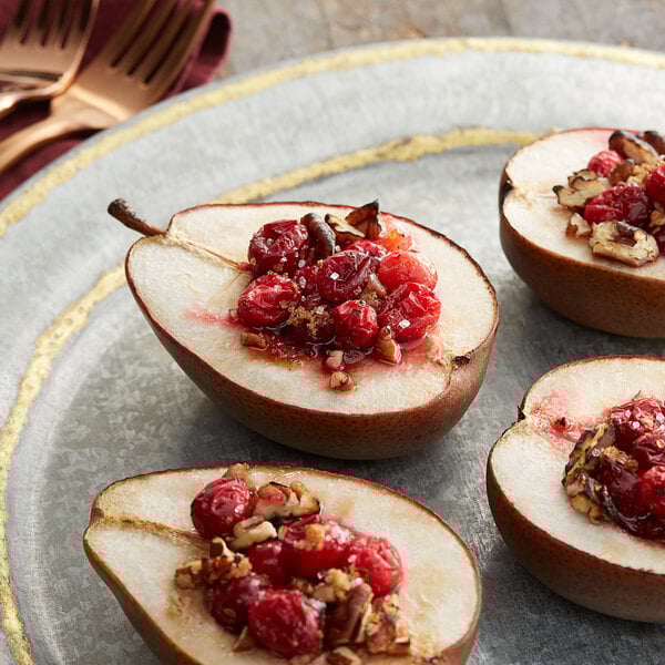 A plate of food with a fork and whole cranberries.