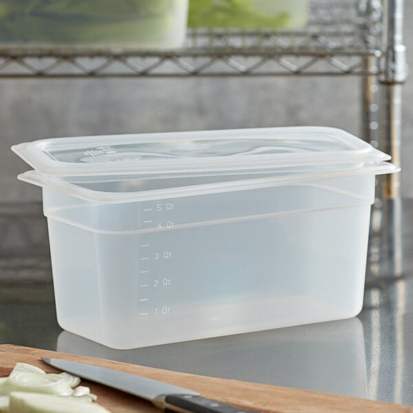 A Cambro translucent polypropylene food pan with a seal lid on a counter.