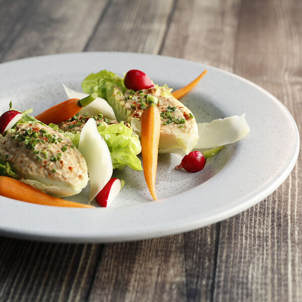 A plate of food with carrots and lettuce in a Corona Cosmos moon wide rim bowl.