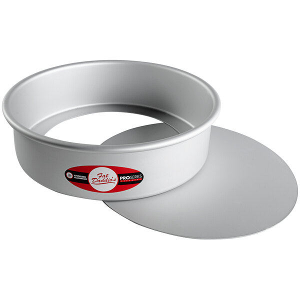 A round silver cake pan with a removable bottom.