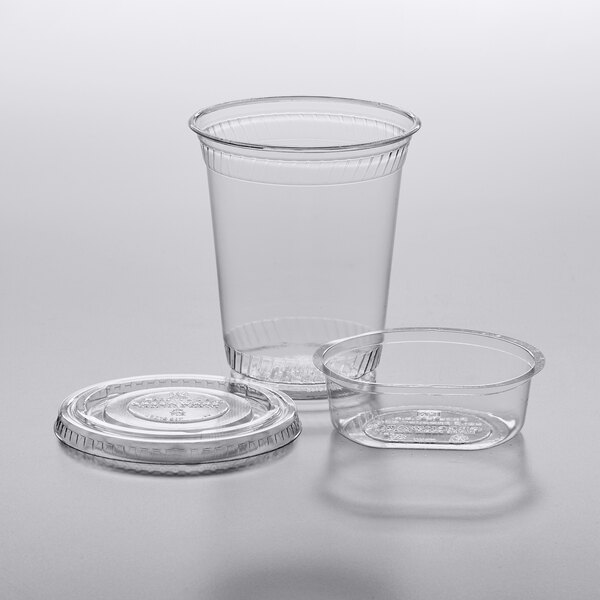 A Fabri-Kal clear plastic parfait cup with an insert and flat lid.