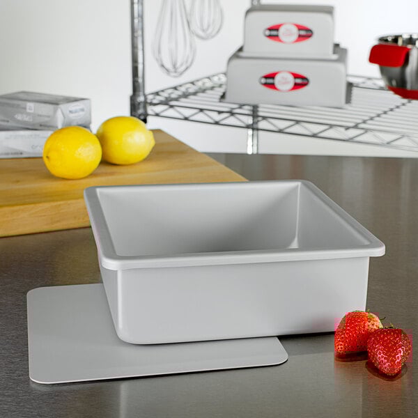 A white rectangular Fat Daddio's cheesecake pan on a table.