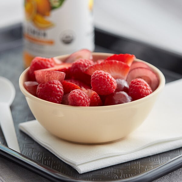 An Acopa Foundations melamine bowl filled with raspberries and strawberries on a table.