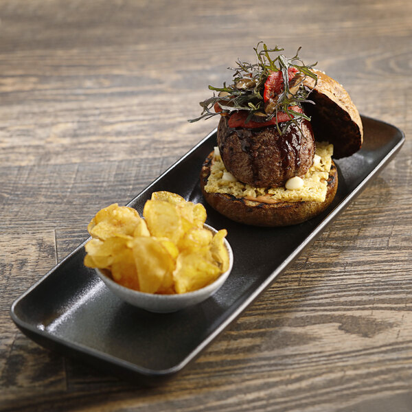 A rectangular platter with a burger and chips.