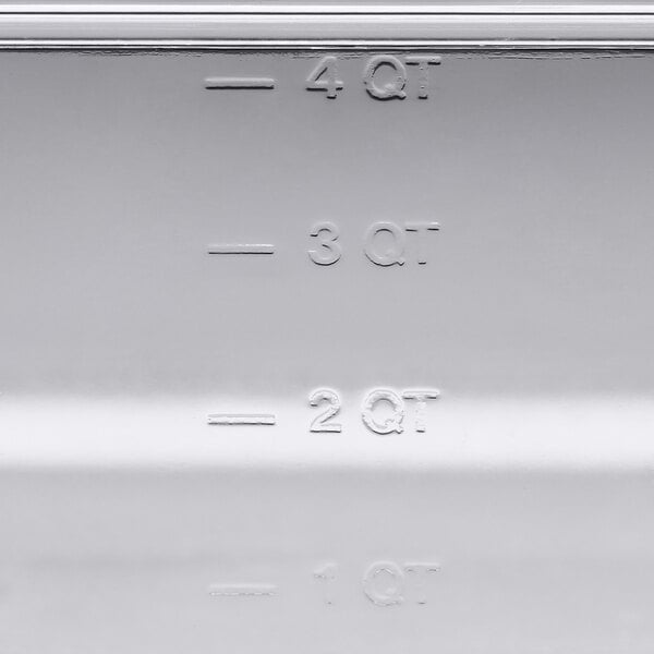 A close up of a clear plastic Vigor food pan on a counter.