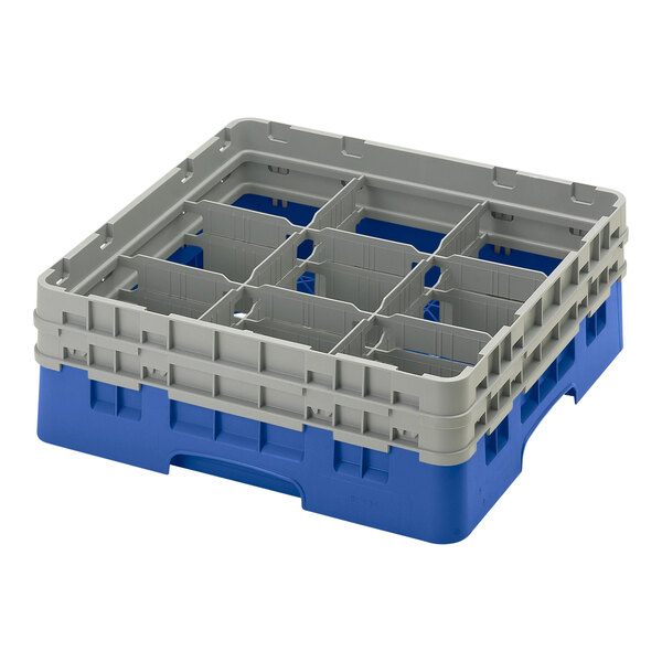 A blue plastic Cambro glass rack with 9 compartments and 2 extenders.