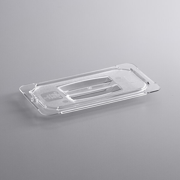 A clear plastic Vigor food pan lid with a handle.