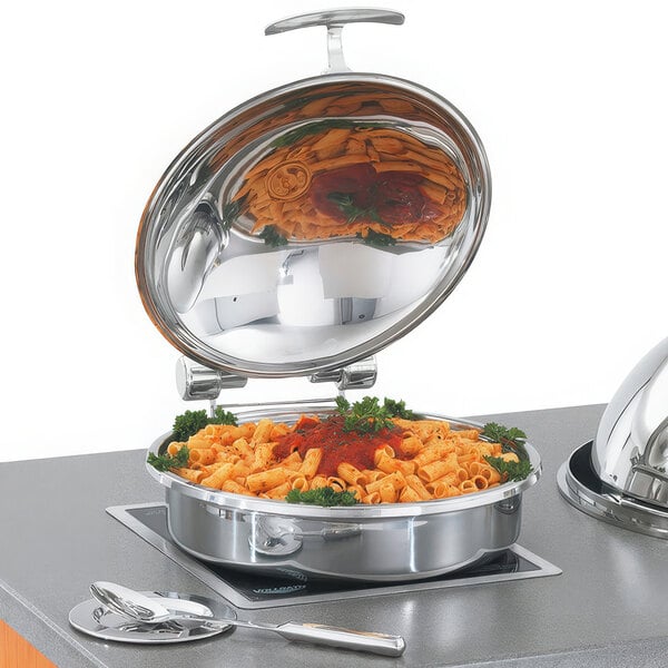 A Vollrath stainless steel chafing dish with pasta and sauce in a stainless steel pan.
