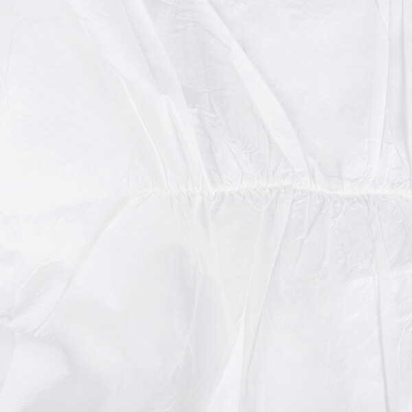 A close-up of a white Cordova microporous coverall with a white background.