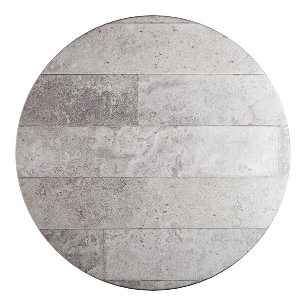 A round table top with a textured gray stone-like finish.