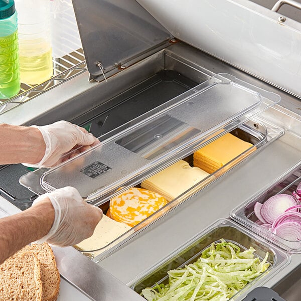 A clear plastic lid on a clear plastic food pan.