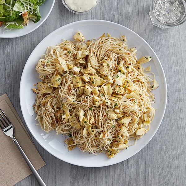 a fork and pasta on a napkin