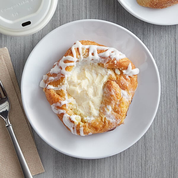 A white Acopa Lunar melamine plate with a pastry and a fork on it.