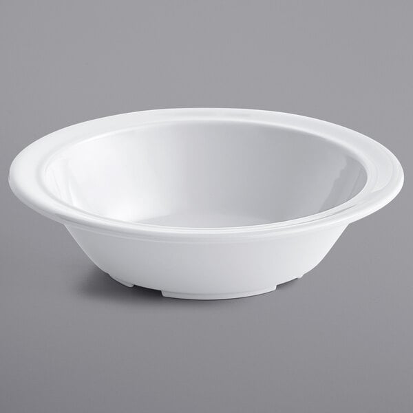 A close up of a white Acopa Foundations melamine bowl on a gray surface.