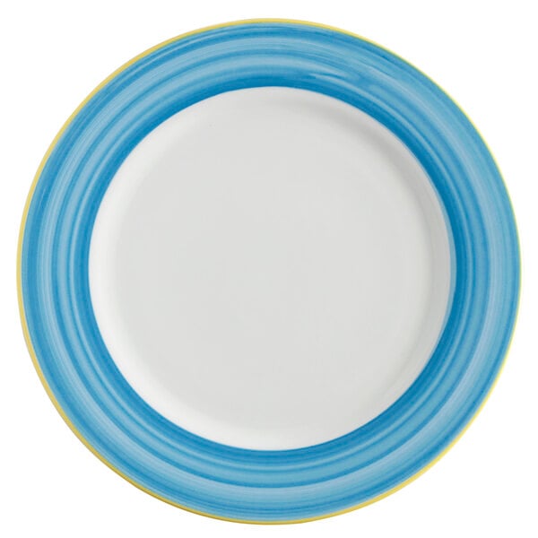 A close-up of a white porcelain plate with a blue and yellow rim.