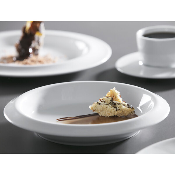 A bright white porcelain bowl filled with food on a table.