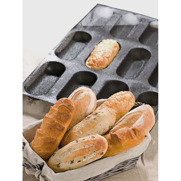 A Sasa Demarle oblong bread mold filled with 12 loaves of bread.