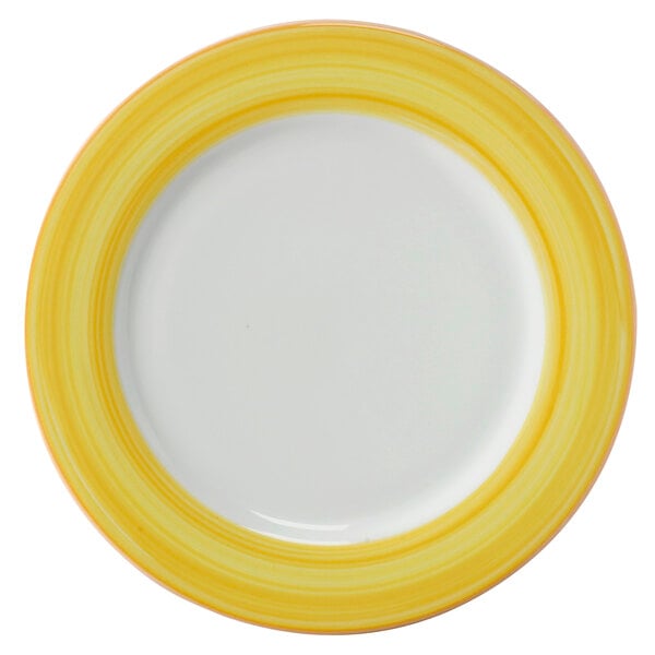 A close-up of a white porcelain plate with a yellow and white border.