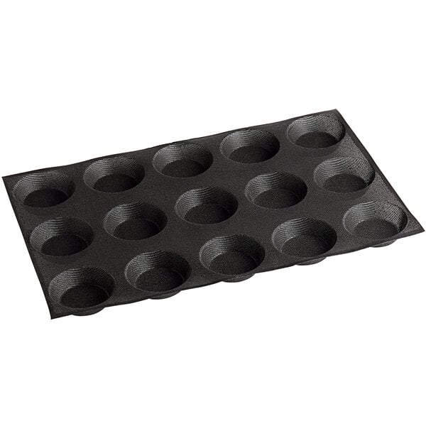 A black Sasa Demarle silicone tartlet mold with 15 compartments.