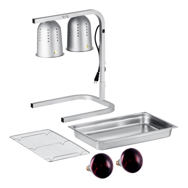 A silver two-bulb free-standing heat lamp food warmer set with red bulbs, a stainless steel pan, and a wire grate.