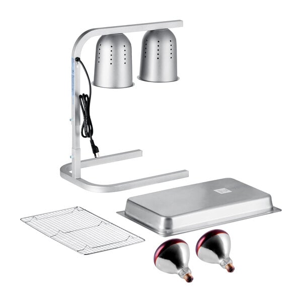 A silver two-bulb free standing heat lamp food warmer set with red bulbs, a pan, and a wire grate.