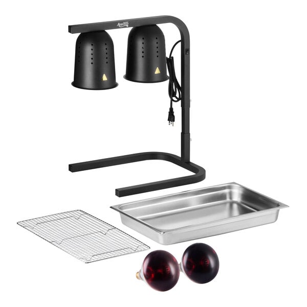 A black two-bulb free standing heat lamp food warmer set with red bulbs, a stainless steel pan, and a wire grate.