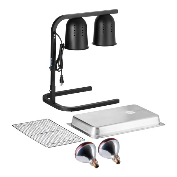A black two-bulb free standing heat lamp food warmer set with red bulbs, a metal pan, and a wire grate.