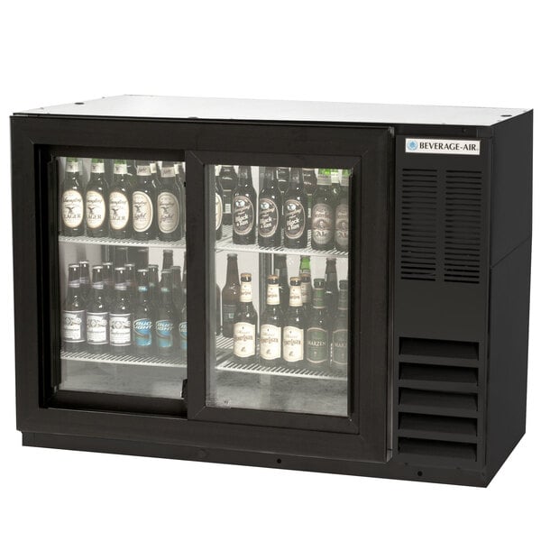 a black refrigerator with bottles of beer