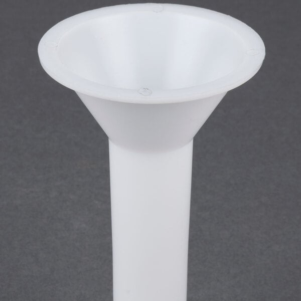 A white funnel with holes on a grey surface.