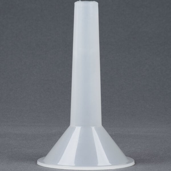 A white plastic funnel on a grey surface.
