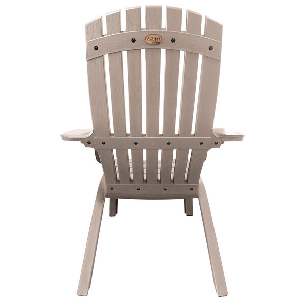 A close-up of a taupe resin Grosfillex Westport Adirondack chair with a backrest and armrest.