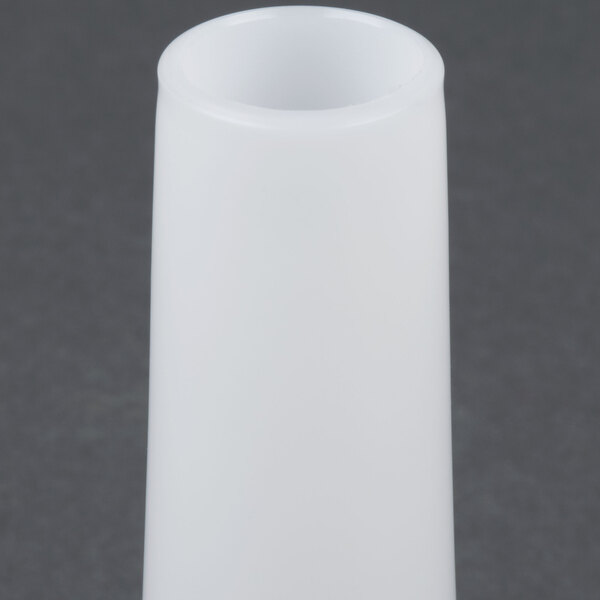 A white cylindrical object with a black handle.