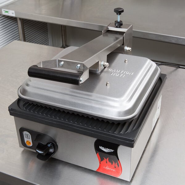 A Vollrath panini sandwich press on a counter.