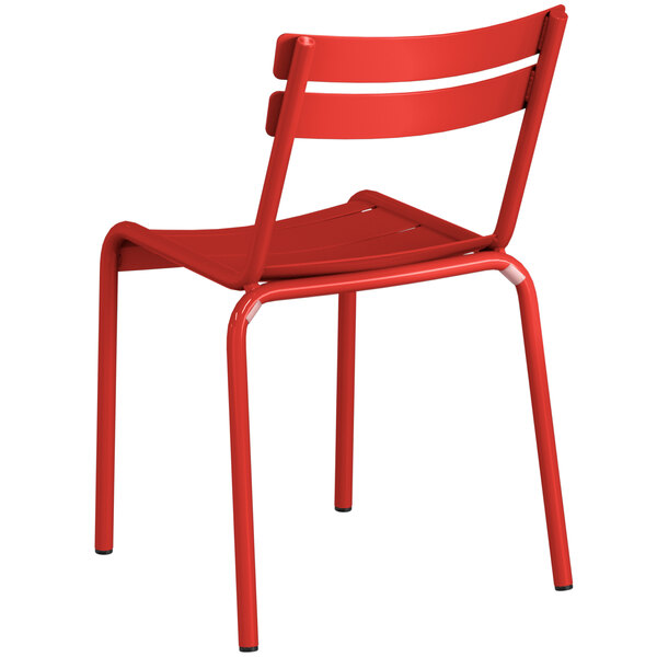 A red Lancaster Table & Seating aluminum outdoor side chair with metal legs.