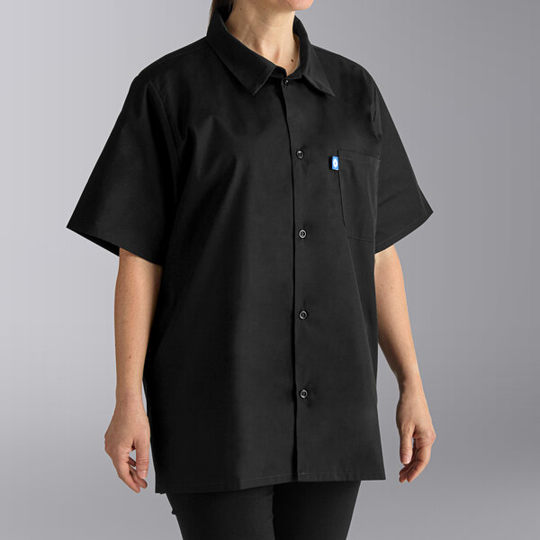 A woman wearing a black Uncommon Chef cook shirt.