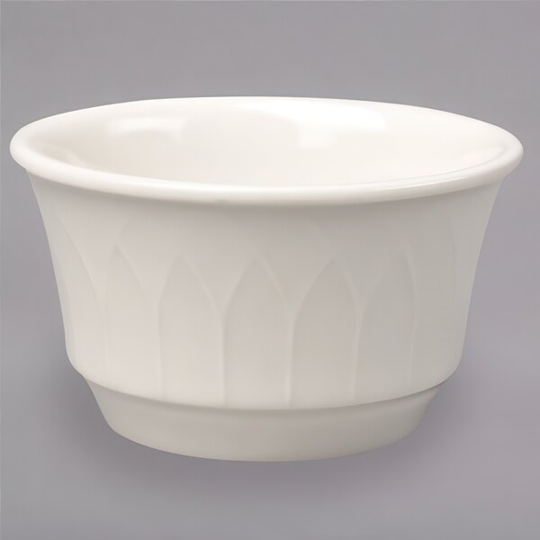 A close up of a Homer Laughlin ivory ramekin on a white background.