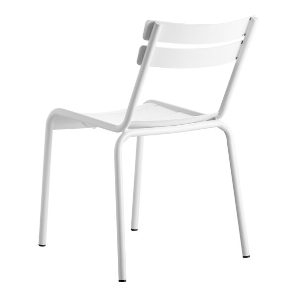 A white Lancaster Table & Seating outdoor side chair with a backrest and metal legs.