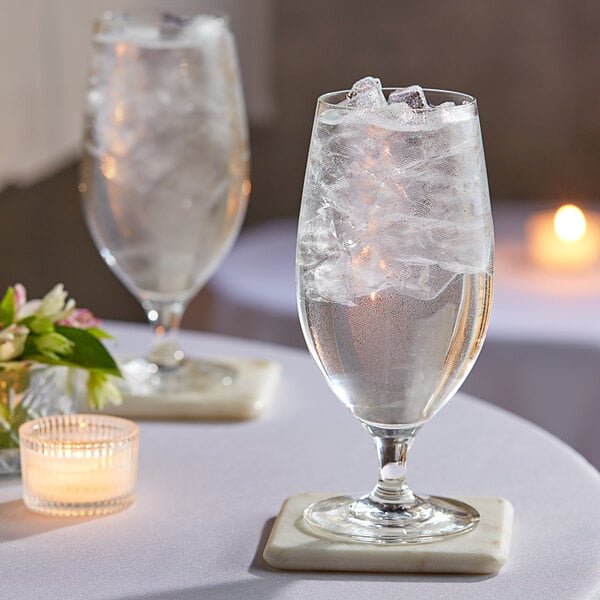 A couple of Schott Zwiesel water goblets on a table.