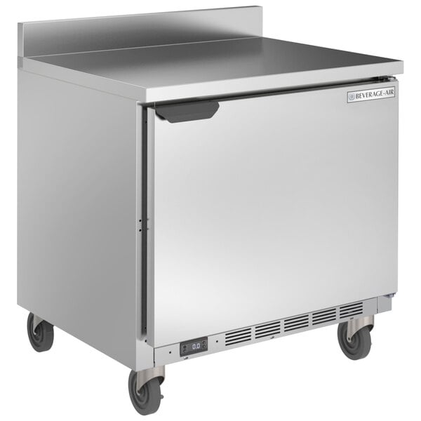 A Beverage-Air stainless steel worktop freezer on wheels with a door.