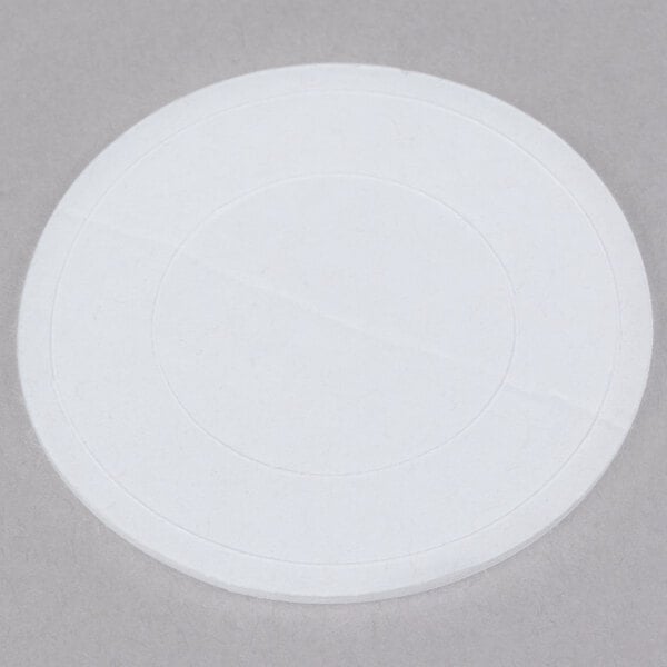 A white circular stick-on thermometer with a black border.