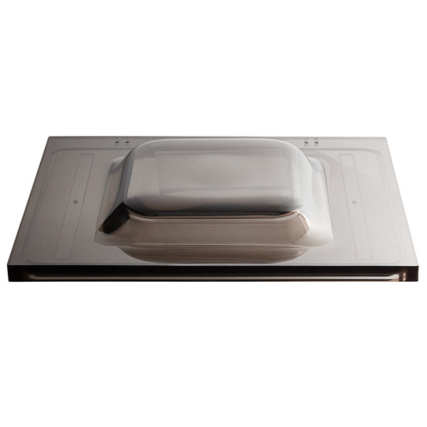 A rectangular metal lid on a VacPak-It VMC20F container.