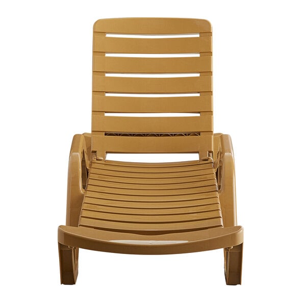A tan plastic Lancaster Table & Seating chaise lounge chair.