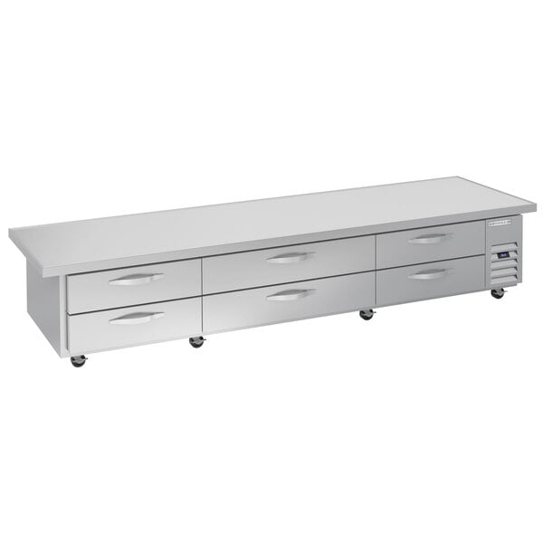 A Beverage-Air stainless steel chef base with six drawers on a long white rectangular table.