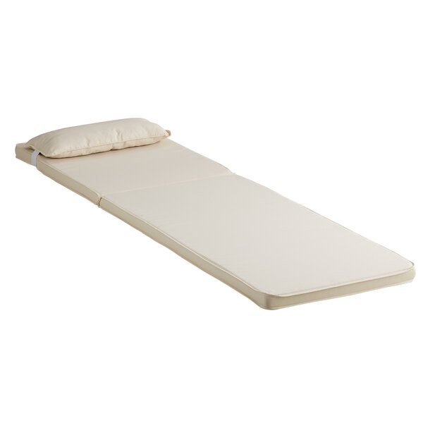 A white chaise cushion with a pillow on top.