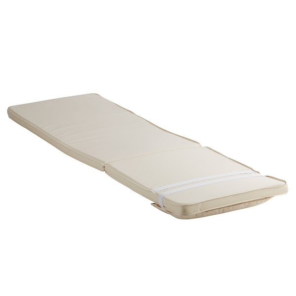 A white Lancaster Table & Seating chaise cushion with straps.